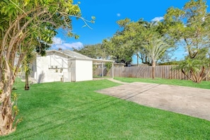 Enjoy a serene outdoor space with a well-manicured lawn and a tree.