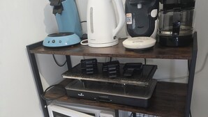 A kitchen counter with a coffee maker, kettle, toaster, and microwave. - Cosy gîte for 2 to 11 people near Gerardmer (Granges-Aumontzey)