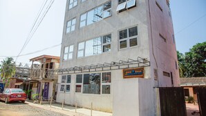 A multi-story building with a sign for 'ARK HOTELS & APARTMENTS'. - Ark Hotel and Apartments (Accra)