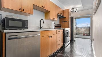 Full-size fridge, microwave, coffee/tea maker, cookware/dishes/utensils