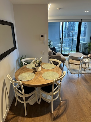 Relax in this stylish living space with a round dining table and city views.