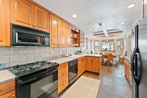 Enjoy cooking in this well-equipped kitchen with a central island, sink, and stove and dishwasher.