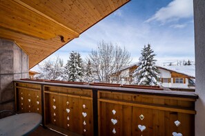 Relax on the balcony with a view of the surrounding landscape and trees.
