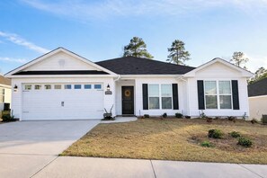 A single-story house with a garage, a front door, and a small front yard. - Modern Ranch-Style Retreat — Prime location for the Course ⛳️ (Augusta)