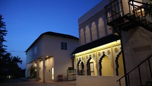 A two-story building with a balcony and a covered entrance area. - PUSHKAR REGENCY RESORT (Pushkar)