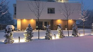 A modern hotel with a flat roof, a visible entrance, and a sign indicating its name. - Hotel Magdalena (Zagreb)