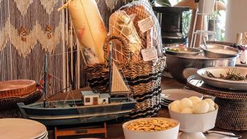 A buffet setup with various food items and a decorative backdrop.
