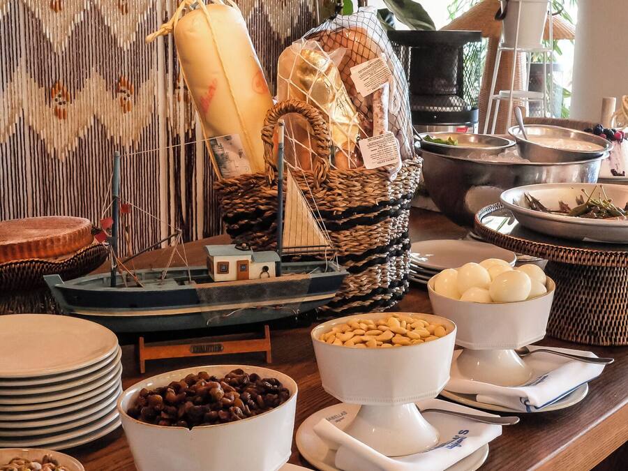 A buffet setup with various food items and a decorative backdrop.