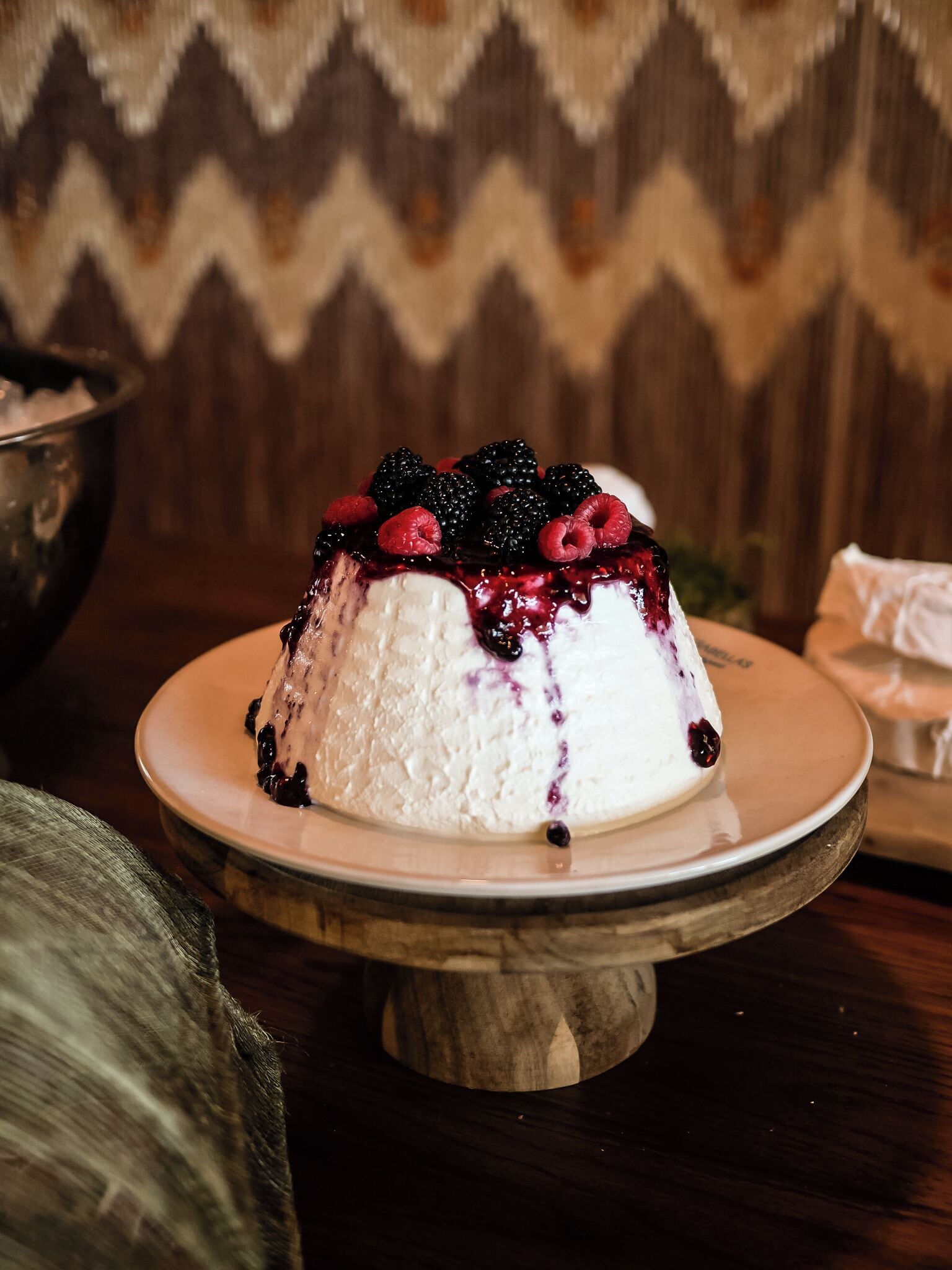 A dessert on a plate with berries on top.