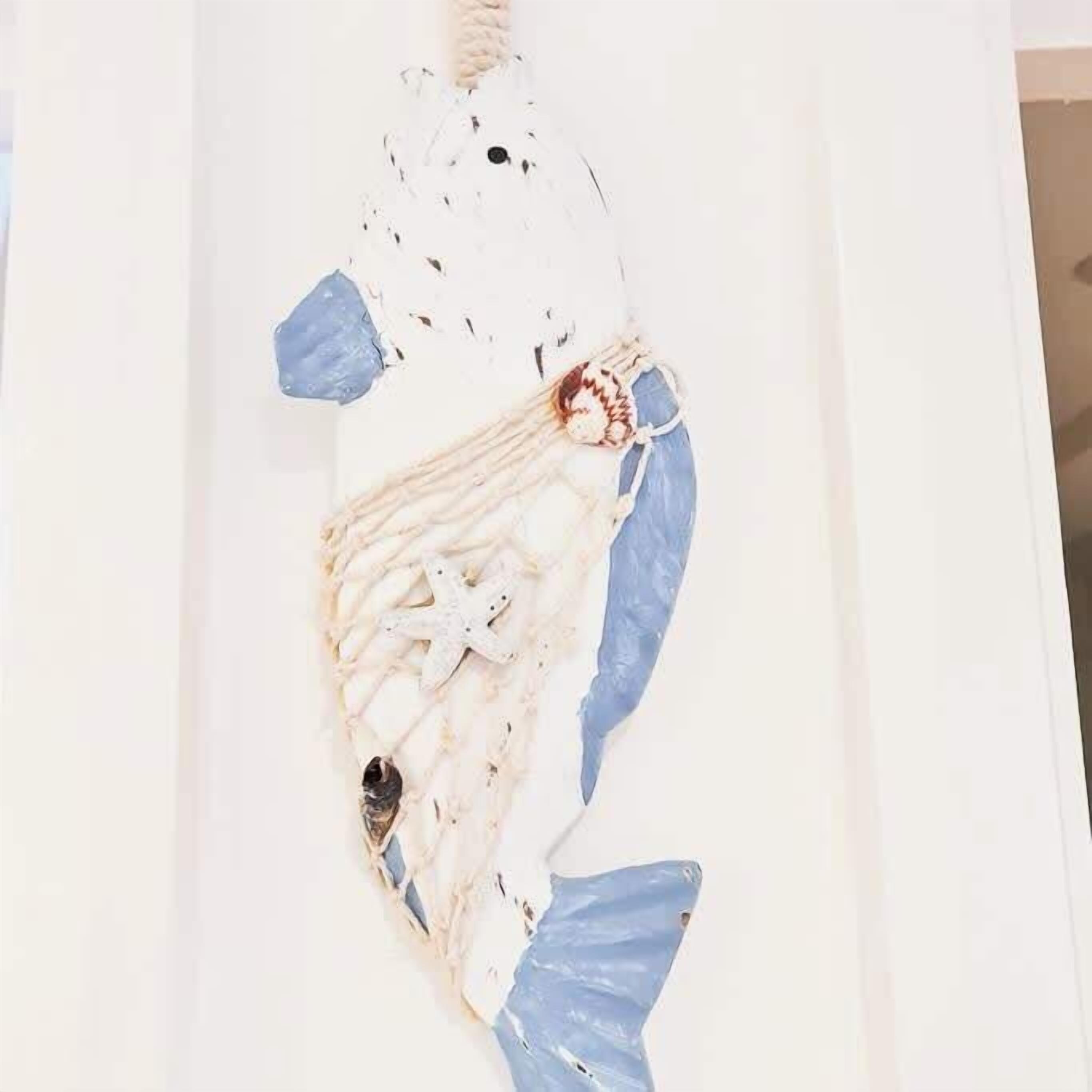 A white wall with a large, abstract sculpture.
