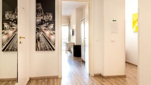 A hallway with a door labeled 505, leading to a room with a bed and a desk. - Aurelia Home Guest House (Rome)