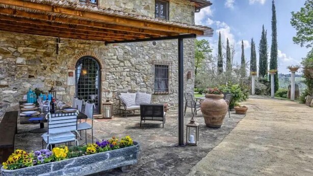 A stone building with a covered patio, outdoor seating, and a flower bed. - Federico farmhouse with swimming pool and jacuzzi, panoramic position in Chianti (castellina in chianti)