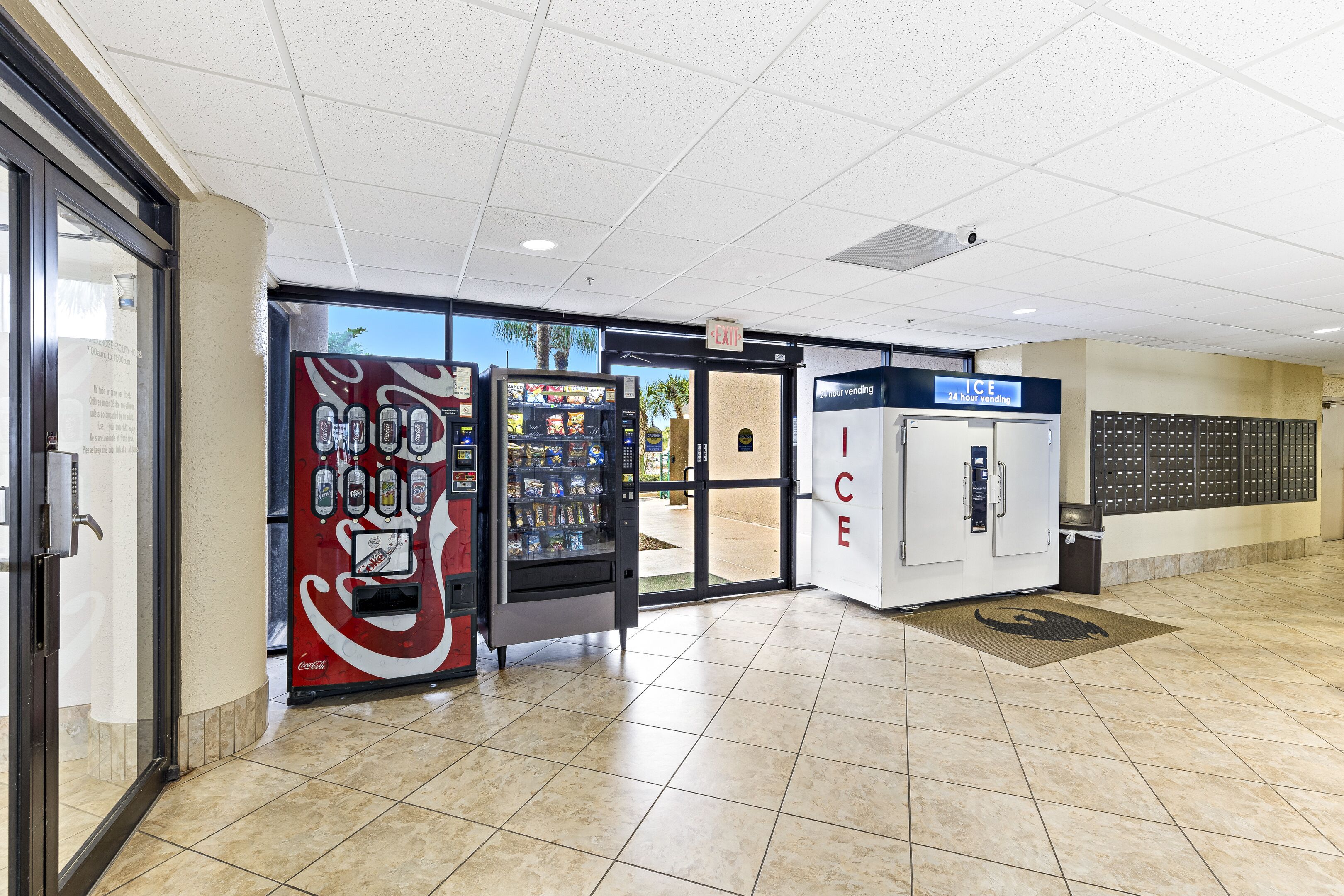 A clean, well-lit indoor area with vending machines, an ice vending machine, and a security kiosk.