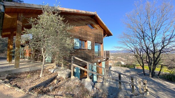 A rustic wooden cabin with a porch and a staircase leading to the entrance. - L'Escapade Ardéchoise (Fons)
