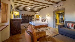 A cozy bedroom with a bed, a leather chair, and a sofa. - CAN FELIP Apartment with Fantastic Views (Palafrugell)