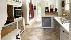 A spacious kitchen with a central island, built-in oven, and ample counter space. - Large air-conditioned family villa with private pool in Provence, French Riviera (Le Rouret)