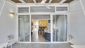 A modern interior with a kitchen area, a dining table, and a bench. - 2 Bed 1.5 Boutique home w pool, with Seaview deck 100 yrds from Bachelor's Beach (Belnem)