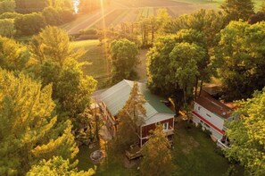 Escape to a serene rural haven surrounded by lush greenery and open fields.