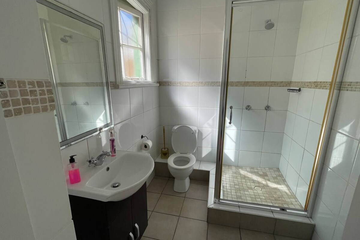 A bathroom with a sink, toilet, and shower.