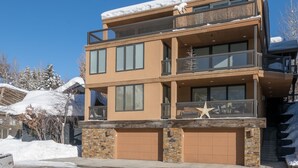 A multi-story building with a stone facade, large windows, and balconies. - Sun Valley, Idaho / Downtown Ketchum Penthouse / Views, Ski, Sun, Prime Location (Ketchum)