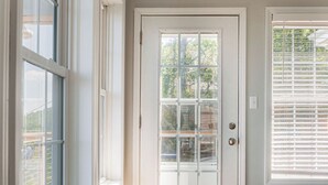 A white door with a glass panel, a window to the left, and a window with blinds to the right. - "Mountain Escape" - Majestic Mountain Sunrises Near Blue Ridge Parkway & I-77 (Fancy Gap)