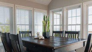 A dining area with a rectangular table, six chairs, and a potted plant. - "Mountain Escape" - Majestic Mountain Sunrises Near Blue Ridge Parkway & I-77 (Fancy Gap)