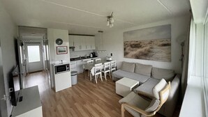 A compact living space with a kitchenette, dining area, and seating area.