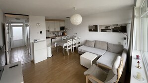 A modern, open-plan living space with a kitchen, dining area, and seating area. - 6 pers. Apartment, 3 sep. Sleeping room, 300 m v. Beach, constantly modernized and clean  (Westkapelle, Zeeland / Walcheren)