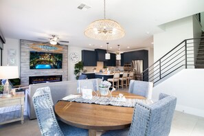 A modern kitchen with dark cabinets, a central island, and stainless steel appliances. - Heritage District Oasis, 300 steps from downtown Gilbert amenities. -Lot 8 (Gilbert)