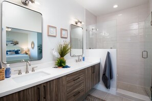 A modern bathroom with a double sink vanity, a large mirror, and a glass shower enclosure. - Heritage District Oasis, 300 steps from downtown Gilbert amenities. -Lot 8 (Gilbert)
