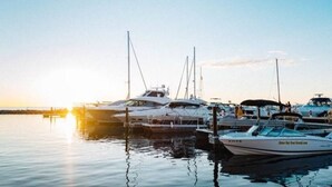 A marina with several boats docked at sunset. - CONDO 5-Sister Bay Gem-Steps to the Beach (Sister Bay)