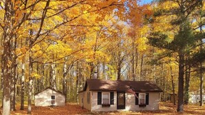 A cabin surrounded by autumn trees.