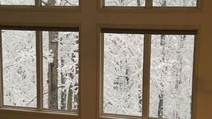 Una habitación con amplios ventanales que dan a un paisaje nevado.