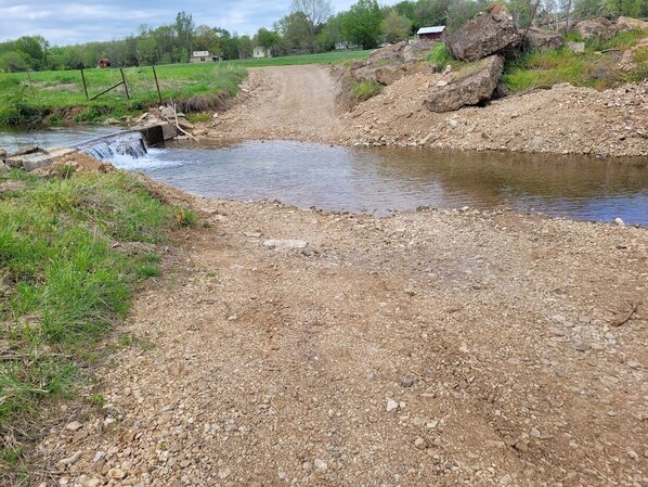 Explore a serene rural landscape along a winding gravel path.
