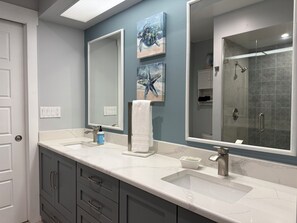 A bathroom with two sinks, a large mirror, and artwork on the wall. - Sarasota Cozy & Clean, Near #1 Beach Siesta in SouthGate Neighborhood (Sarasota)