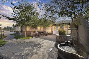 Front entry with sitting area and water fountain.