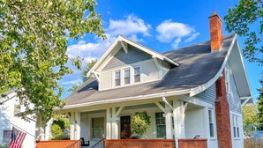 A two-story house with a front porch, a brick chimney, and a well-maintained lawn. - Walk to Shops & Dining, Great Location! - 3br (Perrysburg)