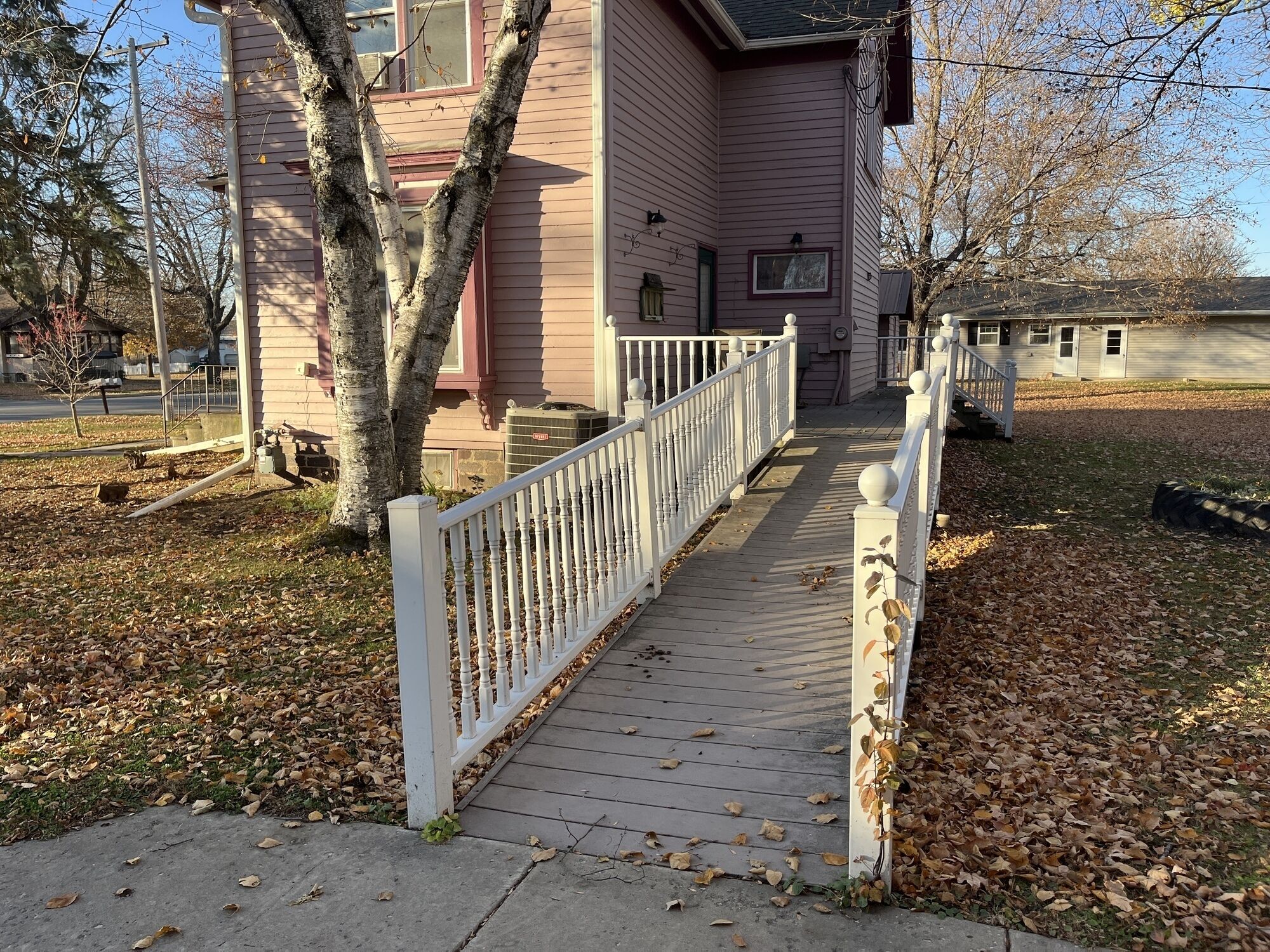 A house with a wooden deck and a white railing.