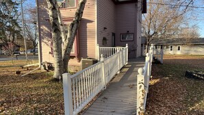 A house with a wooden deck and a white railing.