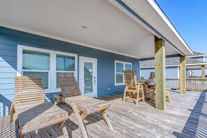 Relax in an outdoor space with comfortable lounge chairs and a table.