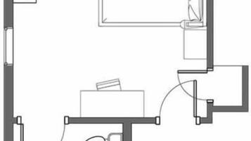 A floor plan with a bedroom, bathroom, and kitchenette.