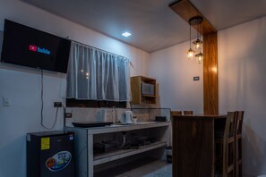 Fridge, microwave, coffee/tea maker, cookware/dishes/utensils