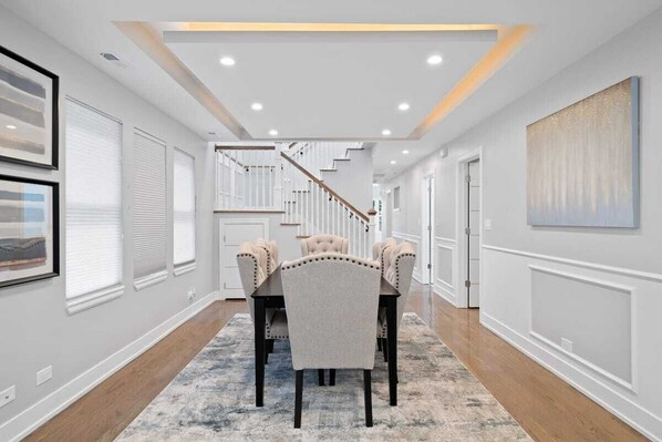 Enjoy meals with family and friends in this stylish dining area, featuring a table for four and comfortable seating.