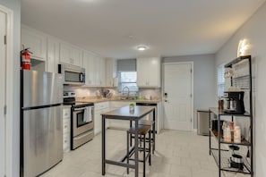 Enjoy cooking in this well-equipped kitchen with a central island, sink, and ample counter space.