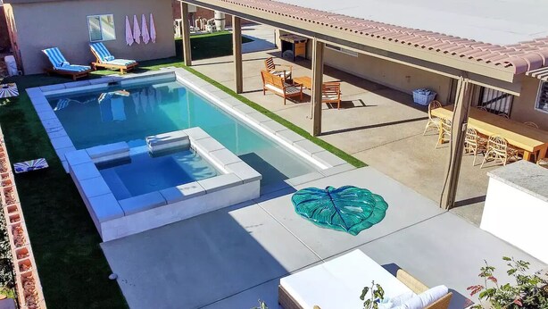 A swimming pool with a hot tub, lounge chairs, and a covered patio area. - Mango Manor - Close to festivals & tennis gardens! (Indio)