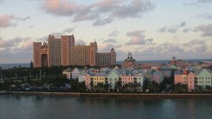 A coastal hotel with a large building and colorful buildings in the foreground. - Harborside Resort @ Atlantis 2 BR Sleep 6-8 (Nassau)