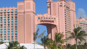 A large hotel with multiple towers and a central archway. - Harborside Resort @ Atlantis 2 BR Sleep 6-8 (Nassau)