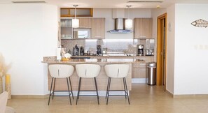 Enjoy cooking in this well-equipped kitchen with a central island and stainless steel appliances.