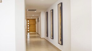 Stylish corridor with framed artworks and a neutral color palette.
