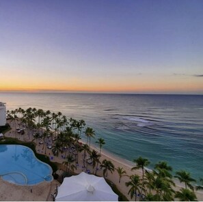Relax by the pool or on the beach, surrounded by palm trees and scenic ocean views.